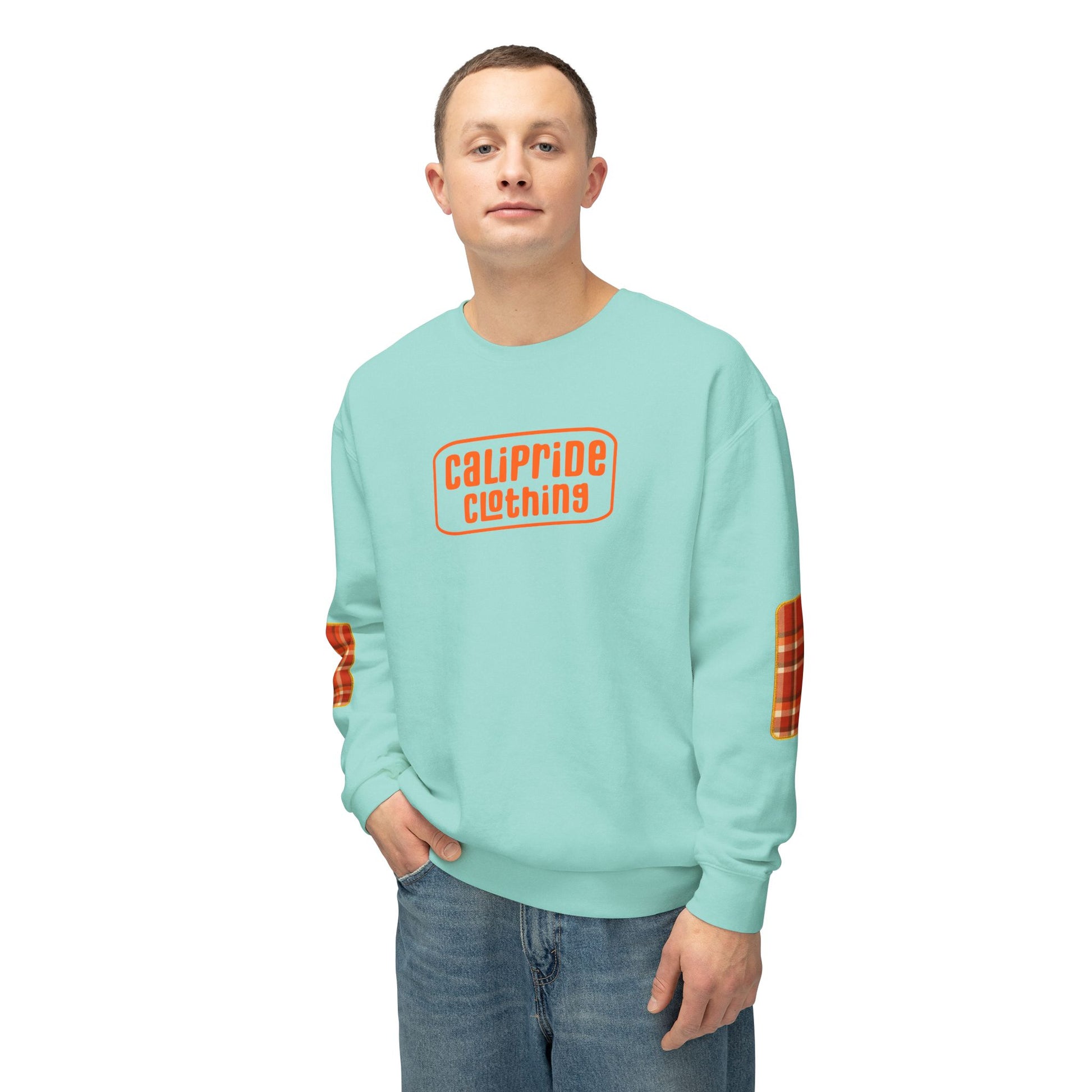 Pacific Plaid Crew, A man wearing a Chalky Mint color crewneck sweatshirt with an orange 'CaliPride Clothing' logo on the chest and orange plaid patches on the sleeves, .