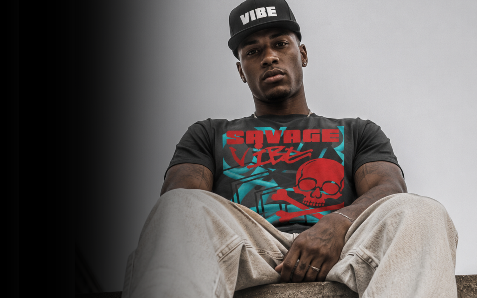 Model wearing a CaliPride Savage Vibe graphic t-shirt and Vibe hat. 